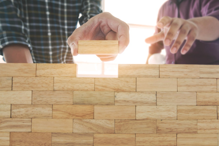 Engineer placing wooden block wall, Planning of project building constructionの写真素材