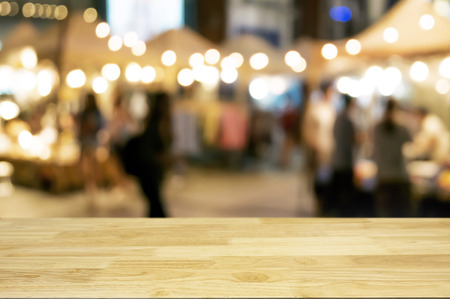 empty wood table with night street market background