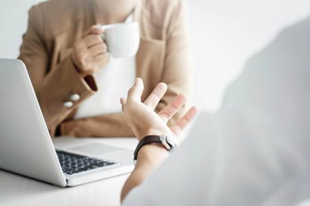 two business executives friendship at a cafe or working space and discussing a projectの写真素材