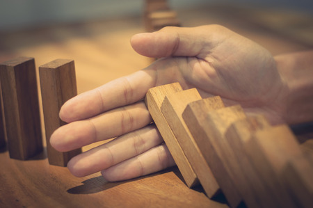 hands with wooden brick block, risk and solution concept.の写真素材