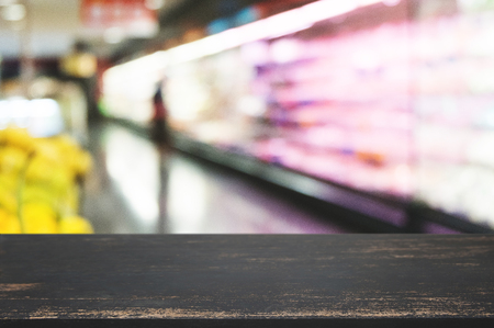 empty wooden table top with blurred with bokeh light of shopping mall background, used for display or montage your productの写真素材