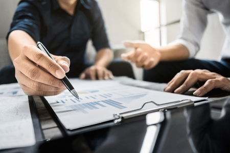 Business executives analyzing on valuation data paperの写真素材