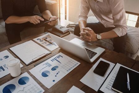 Business executives analyzing on valuation data paperの写真素材