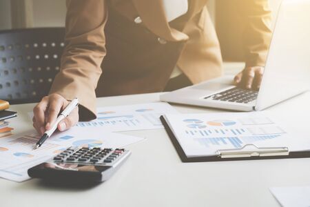 business financier audit working with laptop and data annual reportの写真素材