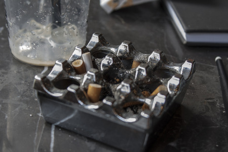 An Ashtray and Some Items on Tableの写真素材