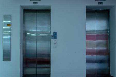 a isolated front view shoot of two elevators with metal doors. photo has taken from an university at...