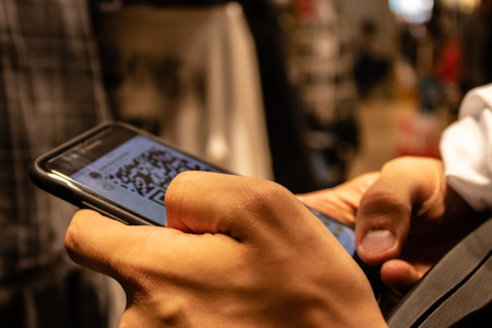 a man holding smartphone and checking something. an isolated concept shoot.の写真素材