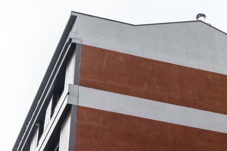 a corner from a modern building with red bricks - white background. photo has taken from...