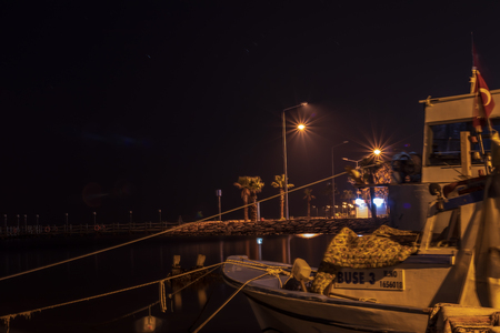 good looking nightscene - there is a boat and city lights. photo has taken at izmir/turkey.のeditorial素材