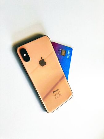 ATHENS - GREECE - MARCH 1, 2019: Close up shot of Apple iPhone XS and Revolut credit card.のeditorial素材
