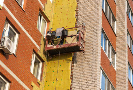 Building the cradle with the workers, repair of a facade of Russiaの写真素材