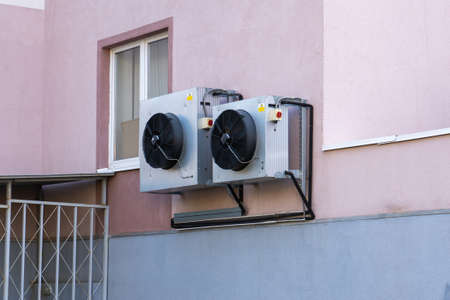 Air conditioning on the outer wall of an office buildingの写真素材