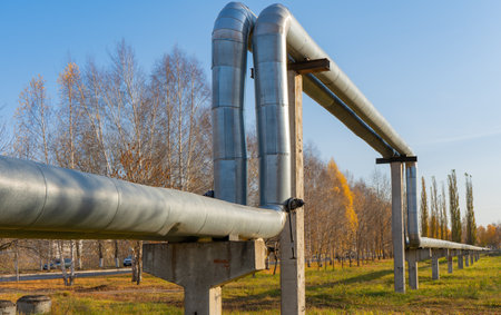 City heat line that conducts heat to residential buildings. Central heating in Russia. Insulated pipe with insulation and aluminum coatingの写真素材