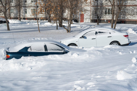 Cars in the courtyard after a blizzard. Winter in Russiaの写真素材