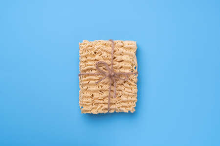 instant noodles, gift wrapped, tied with twine and bowの写真素材