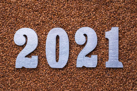 Text in silver numbers 2021 on the background of buckwheatの写真素材
