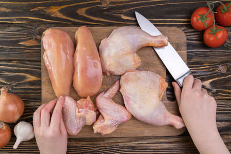 The female chef has finished butchering the chicken. View from aboveの写真素材