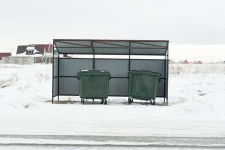 Large green garbage containers in winter under a canopy. Russiaの写真素材