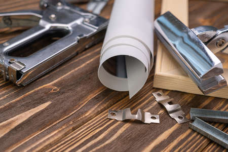 Devices for stretching canvas on a wooden frame. Stapler, canvas roll, wood frame and tensioning tongsの写真素材