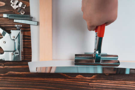 The process of stretching a synthetic canvas onto a stretcher. Printing photos on canvasの写真素材
