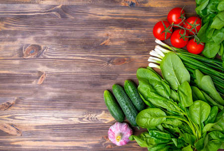 Fresh summer vegetables on brown wooden background, copy-space.の写真素材