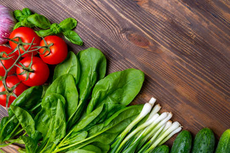Fresh vegetables on a wooden background, ingredients for a vegetarian dishの写真素材