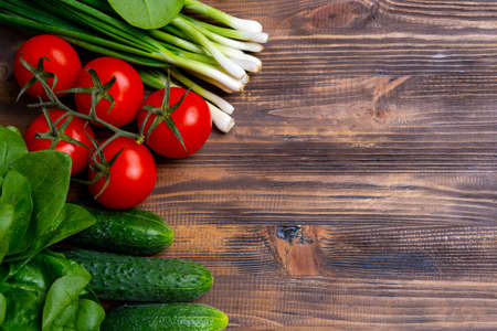 Fresh organic vegetables on brown wooden backgroundの写真素材