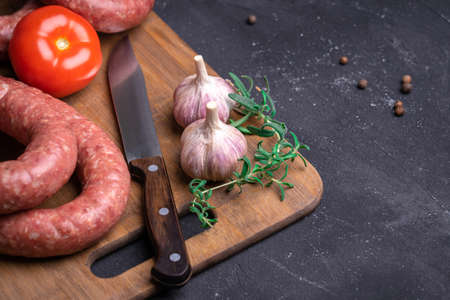 Homemade sausage on a cutting board. Beautiful rings of Krakow sausage, copy-spaceの写真素材