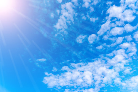 Blue sky on a sunny day, beautiful sun rays in the sky with beautiful cloudsの写真素材