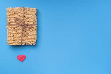 instant noodles, gift wrapped, tied with twine and bow. Copy-spaceの写真素材