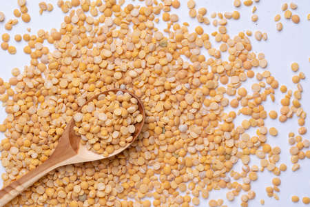 Grains of yellow dry peas, in a wooden spoon. Top viewの写真素材