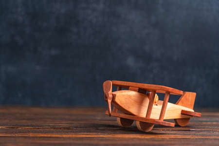 Wooden biplane toy on the background of the blackboardの写真素材