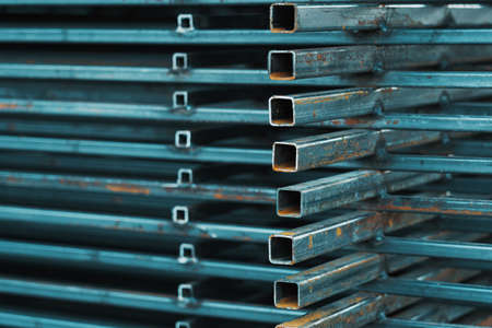 A stack of steel material at a construction site. Square metal profileの写真素材