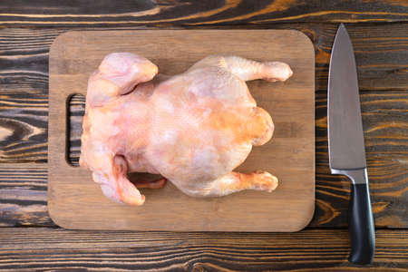 Fresh homemade chicken carcass on a cutting board, top viewの写真素材
