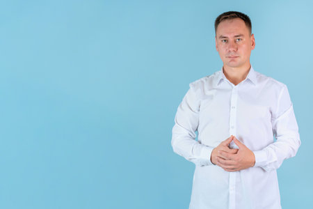 Confident man in a white 30s shirt on a blue background, copyspaceの写真素材