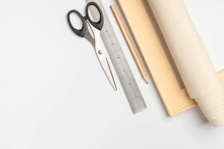 A tool for stretching natural canvas on a wooden stretcher. Wooden stretcher, canvas and ruler with pencil and scissorsの写真素材