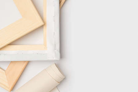 Wooden stretchers and a roll of canvas on a white background, copy spaceの写真素材