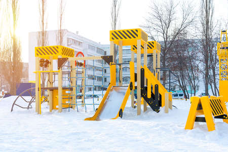 Modern children's playground in the courtyard of an apartment building in Russia, winter time.の写真素材