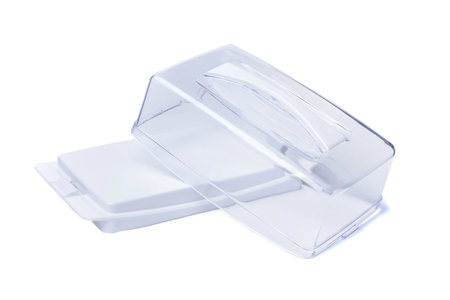 Empty plastic butter container with open transparent lid insulated on white backgroundの写真素材