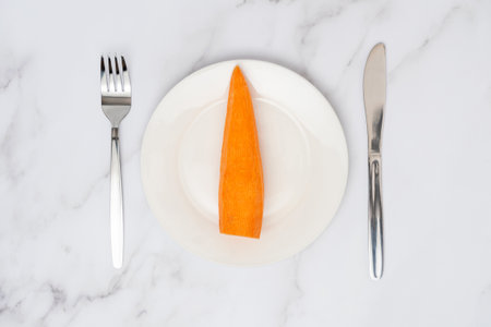Carrot on a white plate top viewの写真素材