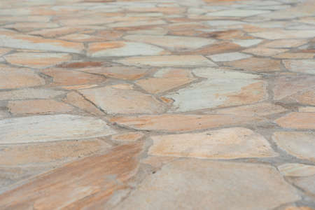 Garden path made of yellow sandstone stones close-upの写真素材