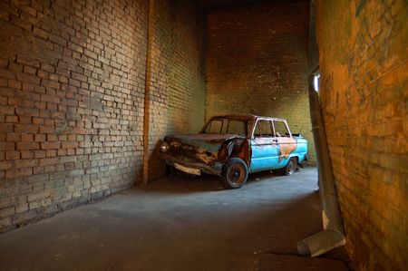 Burned car in brick gatewayの写真素材