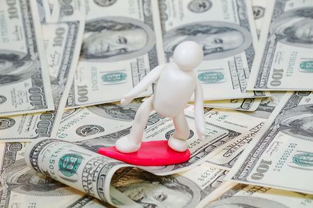 plasticine surfer on the wave of moneyの写真素材