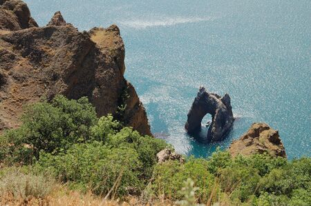 boat under Golden Gate rock in Karadag reserveの写真素材