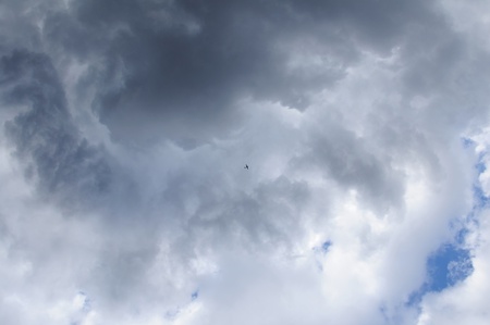 Airplane in the sky  Clouds shows the weather changing の写真素材