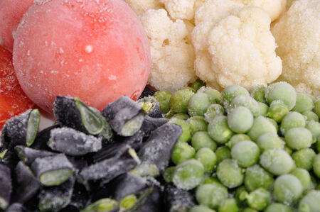 heap of frozen tomato, asparagus, peas and cauliflowerの写真素材
