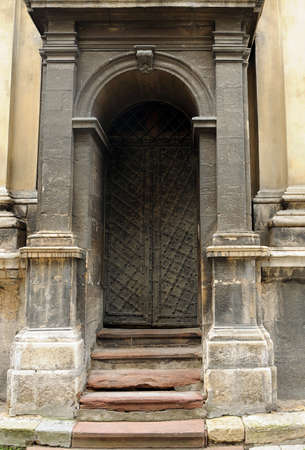Old black iron door in stone building with columnsのeditorial素材