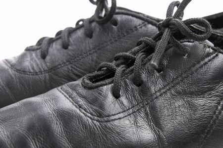 Lacing on a black leather ballroom shoes on white backgroundの写真素材