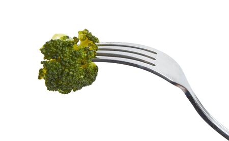 Piece of broccoli on a fork isolated over white backgroundの写真素材