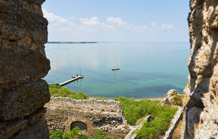 Sailing boat near a pier. View from Akkerman fortress ( Bilhorod-Dnistrovskyi, Ukraine) the historical and architectural monument of the 13th centuries.の写真素材